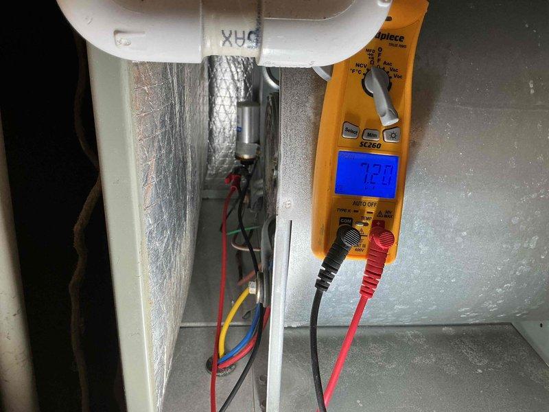 Completed Silver Comfort Plan clean and check service on air conditioning system. Performed comprehensive inspection including electrical diagnostics with multimeter readings, temperature measurements across heat exchanger components registering 72.8°F, and visual assessment of condenser coil condition. All system components tested and operating within normal parameters, with comfort plan renewal collected on-site as requested.