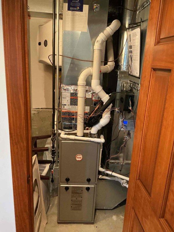 Completed spring clean and check maintenance on two air conditioning systems per Comfort Plan agreement. Performed comprehensive inspection and servicing of indoor Payne furnace unit with integrated cooling coil, including filter evaluation, electrical connection verification, and condensate drain system assessment. Inspected outdoor condensing units, checking refrigerant line connections, service ports, and copper line insulation integrity. Also completed previously missed maintenance on water heater #1 per Gold Care Plan protocol, ensuring all equipment is operating within manufacturer specifications for the cooling season.