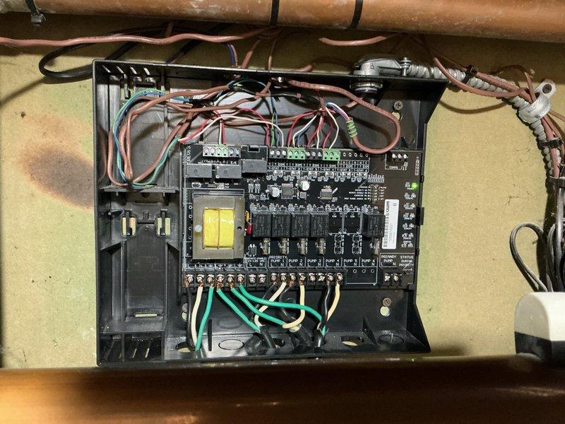Responded to ongoing issue with three-zone hydronic heating system experiencing unwanted heat transfer to upper floor when basement zone calls for heat. Inspected Caleffi zone control board (previously replaced under warranty) and documented control panel wiring, relay configuration, and Weil-McLain boiler control interface. Investigated potential flowcheck valve bypass condition that may be allowing heated water to circulate improperly between zones, collected diagnostic information and photographs for technical support consultation to determine if zone control board malfunction is contributing to cross-zone heating issue.