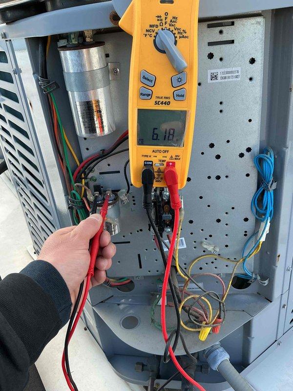 Completed scheduled commercial preventive maintenance inspection per service agreement. Performed electrical diagnostics using digital multimeter, testing capacitor and verifying proper voltage readings at 6.18 on system components. Inspected DiversiTech disconnect panel, confirmed all electrical connections secure, and verified proper operation of safety disconnect switch. Unit operating within normal parameters, no deficiencies noted.