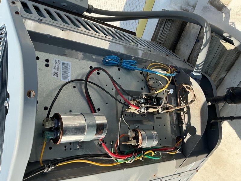 Performed comprehensive preventive maintenance inspection on commercial air conditioning system per service agreement. Inspected internal components including dual capacitors, electrical connections, control board, and verified proper wiring integrity with all color-coded connections secure. Documented condenser unit operation with fan assembly and confirmed equipment mounted on proper protective pad with adequate clearance for airflow through louvered panels.