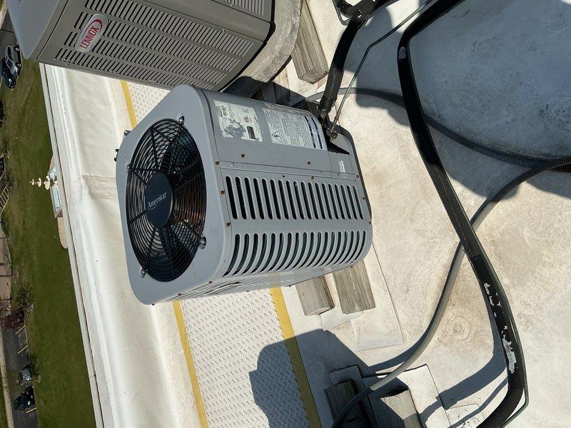 Performed comprehensive preventive maintenance inspection on commercial air conditioning system per service agreement. Inspected internal components including dual capacitors, electrical connections, control board, and verified proper wiring integrity with all color-coded connections secure. Documented condenser unit operation with fan assembly and confirmed equipment mounted on proper protective pad with adequate clearance for airflow through louvered panels.
