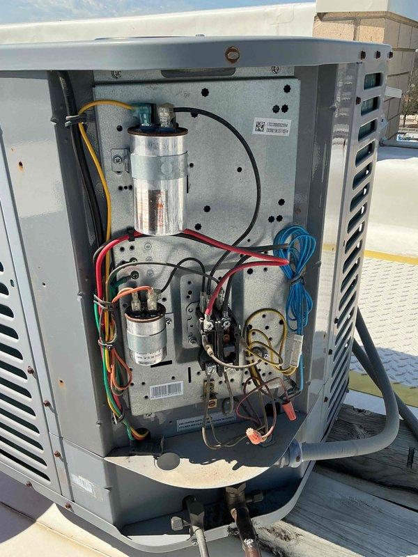 Completed spring preventive maintenance and tune-up on rooftop air conditioning system. Performed comprehensive inspection of electrical components including capacitors and wiring connections, verified system operation with digital multimeter readings, and documented equipment condition through photographic records. All components found to be in functional condition with normal wear for outdoor installation.