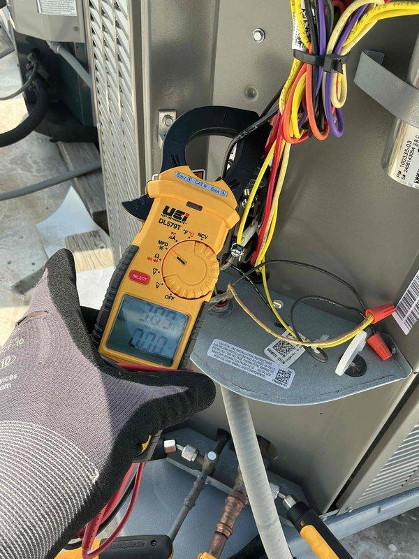 Performed comprehensive tune-up on single HVAC system including air conditioning and air handler units. Conducted electrical diagnostics using digital multimeter to verify proper voltage and amperage readings across system components. Inspected and tested capacitor, motor assembly, and all electrical connections with particular attention to wiring harnesses and terminations. Verified proper operation of blower assembly and confirmed all safety labels and specifications were legible. System tested and found operating within normal parameters. Customer provided their own air filter for installation. All components checked, cleaned, and confirmed in good working condition.