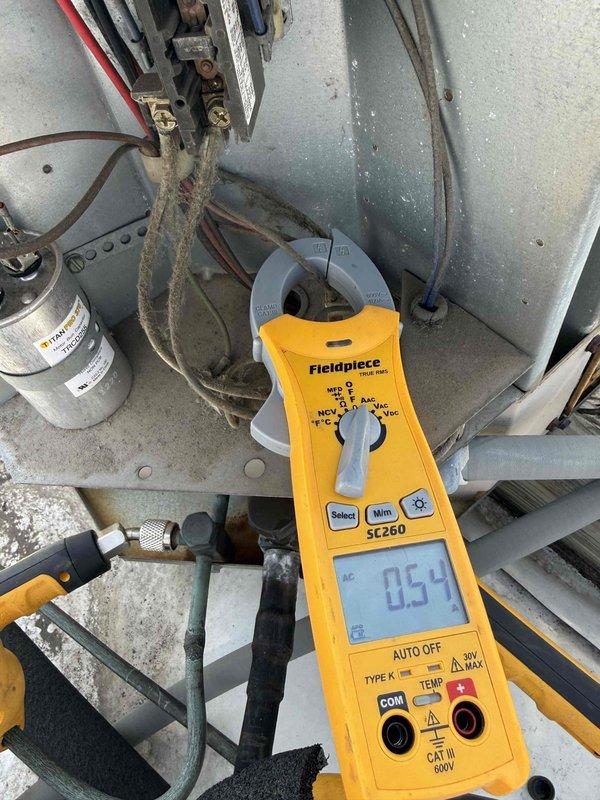 Performed contracted commercial air conditioning maintenance and cleaning service. Conducted electrical diagnostics using digital multimeter to verify proper system operation, measuring voltage and amperage at contactor terminals and capacitor. Inspected and tested all electrical connections, contactors, and capacitor for proper function and secure mounting within the equipment compartment.