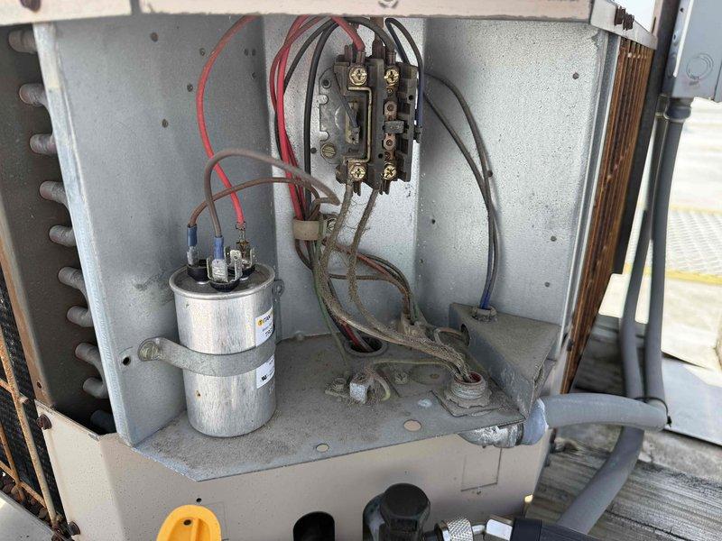 Performed contracted commercial air conditioning maintenance and cleaning service. Conducted electrical diagnostics using digital multimeter to verify proper system operation, measuring voltage and amperage at contactor terminals and capacitor. Inspected and tested all electrical connections, contactors, and capacitor for proper function and secure mounting within the equipment compartment.
