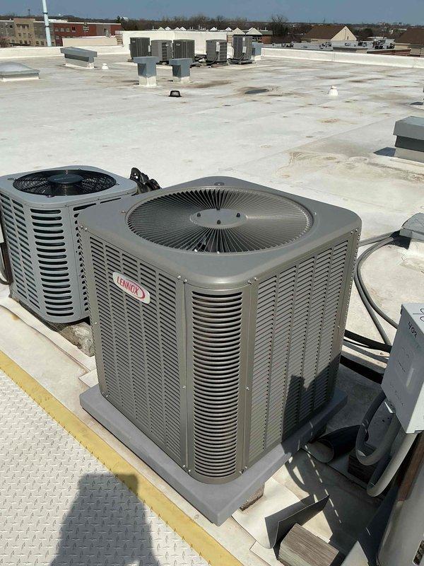 # Commercial HVAC Preventive Maintenance Completed

Performed scheduled preventive maintenance on multiple Lennox rooftop air conditioning units per commercial maintenance agreement. Conducted comprehensive cleaning and inspection of all condenser units, including examination of louver panels, top discharge grilles, and electrical connections. Verified proper mounting and pad stability for all equipment. Inspected rooftop installation conditions, checking for proper drainage and membrane integrity around unit locations. All systems operational and functioning within normal parameters upon completion of contracted maintenance services.