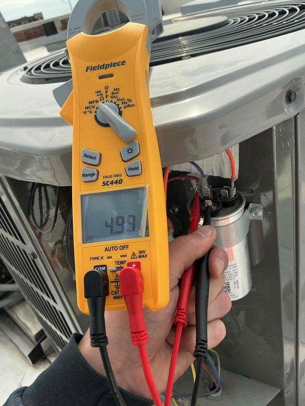 Performed commercial preventive maintenance inspection per service agreement on rooftop AC unit. Conducted electrical diagnostics using clamp meter, measuring voltage and amperage readings on system components. Verified capacitor operation and tested electrical connections throughout the unit. All measurements within normal operating parameters. System operating properly with no deficiencies noted.