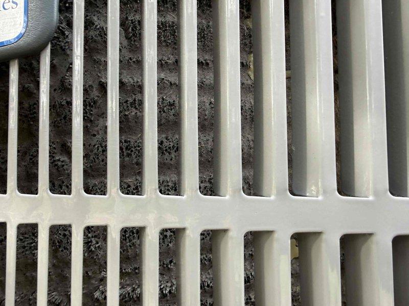 Completed spring clean and check on air conditioning system per comfort plan maintenance agreement. Inspected evaporator coil and found moderate dust and debris accumulation between fins, which can reduce system efficiency and airflow. Additionally, performed diagnostic inspection of 10-year-old water heater per customer request, documenting unit dimensions and current condition with photographs for service records.