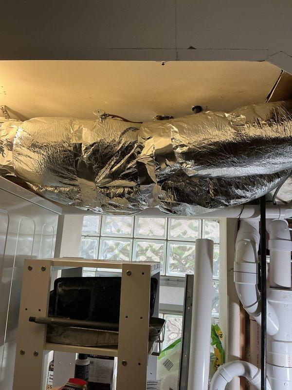 Completed comprehensive plumbing and HVAC system integration work at residential property. Piped 1/2" recirculation line into tankless water heater and connected to main recirculation line, replacing unistrut clamps with cushion clamps for proper support. Removed two temporary 1/2" ball valves previously installed for shower, capped cold line, and installed 1/4" compression x 1/2" compression angle stop on hot line for humidifier connection. Reworked condensate drain system for AC coil and humidifier to ensure proper drainage. Rerouted ERV flex lines to run over main hot and cold water lines, eliminating interference issues. Connected ERV 2-wire control wiring from energy recovery ventilator unit and ran to interface module location. Completed electrical wiring of interface module to control ERV and humidifier operation. Programmed thermostat to communicate with interface module for integrated system control. Programmed tankless water heater settings to properly operate recirculation p