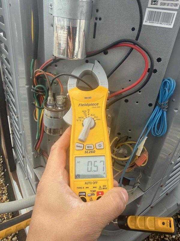 Completed preventive maintenance tune-up on single-system rooftop EcoGuide air conditioning unit. Performed comprehensive electrical diagnostics using clamp meter, measuring amperage draws and verifying proper electrical operation of compressor and fan motor circuits. Inspected capacitor condition, refrigerant line connections, and overall system components. Unit operating within normal parameters; customer provided own filter for replacement. System checked and cleared for continued operation.