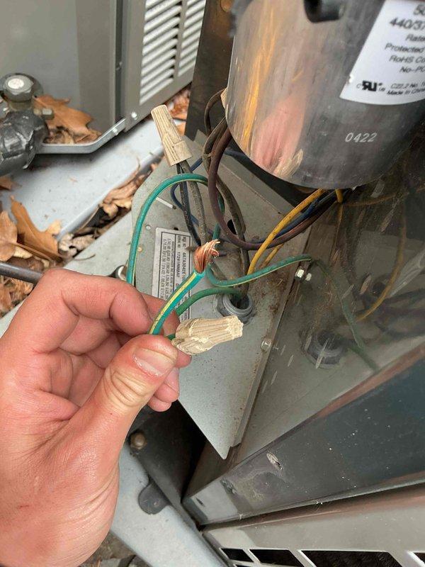 Completed spring clean and check maintenance on two air conditioning systems per Goodman Comfort Plan agreement. Performed comprehensive inspection of HVAC equipment including electrical connections, capacitor testing with Klein Tools NCVT meter, and motor component evaluation. Changed two media filters per plan specifications and documented equipment condition with photos showing electrical junction box, wiring connections, and system components with visible age-related discoloration on cylindrical motor assembly marked "0422."