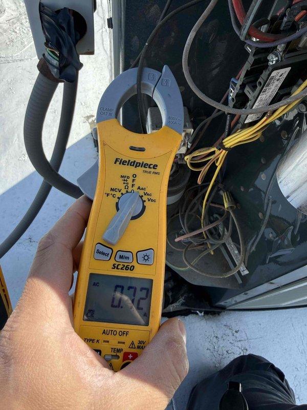 Completed Comfort Plan clean and check maintenance on 14-year-old residential air conditioning system. Performed comprehensive inspection of indoor furnace unit and outdoor condensing unit, including visual assessment of electrical connections, refrigerant lines, and ductwork. Measured electrical parameters using clamp meter to verify proper system operation and component performance within manufacturer specifications.