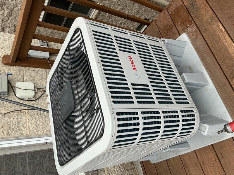 Completed annual air conditioning clean and check maintenance per comfort plan agreement on Bosch system. Performed comprehensive inspection of outdoor condensing unit and indoor air handler control board, verified all electrical connections and components operating within normal parameters, documented system condition with photos showing circuit board with proper LED indicators and clean outdoor unit with intact housing and protective guards.