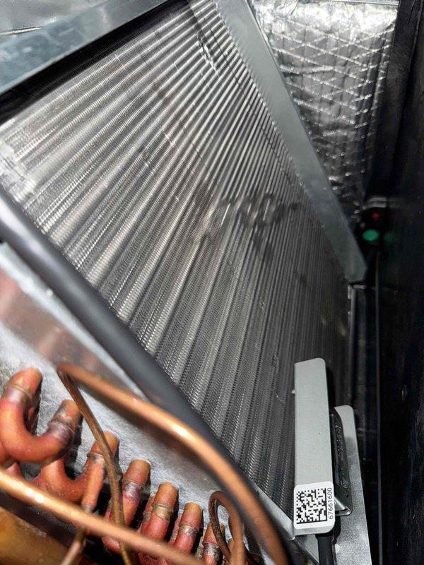 Completed comprehensive tune-up on single HVAC system including inspection of capacitor, evaporator coil assembly, and refrigerant lines. All components found in operational condition with capacitor showing normal wear patterns, evaporator coil fins intact, and copper refrigerant lines properly routed with adequate insulation. System documentation photographed for service records.