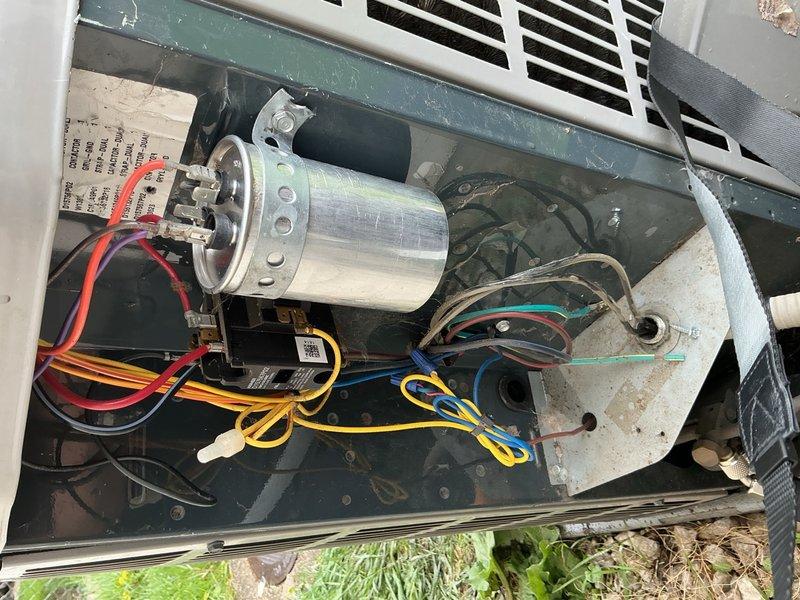 Responded to no cooling complaint on residential air conditioning system. Upon arrival, performed diagnostic testing on outdoor condensing unit. Visual inspection revealed aged equipment with significant debris accumulation on condenser coil surfaces affecting heat transfer efficiency. Conducted electrical diagnostics with multimeter on capacitor and associated components. Testing identified failed dual run capacitor preventing proper compressor and condenser fan motor operation. Removed defective capacitor and installed replacement unit with correct microfarad ratings. Verified proper electrical connections and terminal integrity. Cycled system through complete startup sequence and confirmed compressor engagement and condenser fan motor operation. Monitored amperage draw on both circuits to ensure operation within manufacturer specifications. System cooling properly and maintaining temperature setpoint at time of departure.