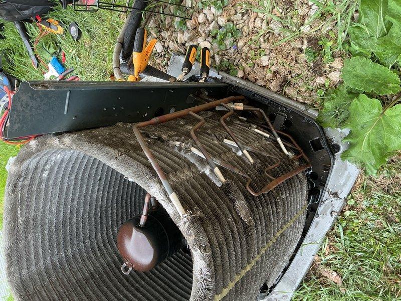 Responded to no cooling complaint on residential air conditioning system. Upon arrival, performed diagnostic testing on outdoor condensing unit. Visual inspection revealed aged equipment with significant debris accumulation on condenser coil surfaces affecting heat transfer efficiency. Conducted electrical diagnostics with multimeter on capacitor and associated components. Testing identified failed dual run capacitor preventing proper compressor and condenser fan motor operation. Removed defective capacitor and installed replacement unit with correct microfarad ratings. Verified proper electrical connections and terminal integrity. Cycled system through complete startup sequence and confirmed compressor engagement and condenser fan motor operation. Monitored amperage draw on both circuits to ensure operation within manufacturer specifications. System cooling properly and maintaining temperature setpoint at time of departure.