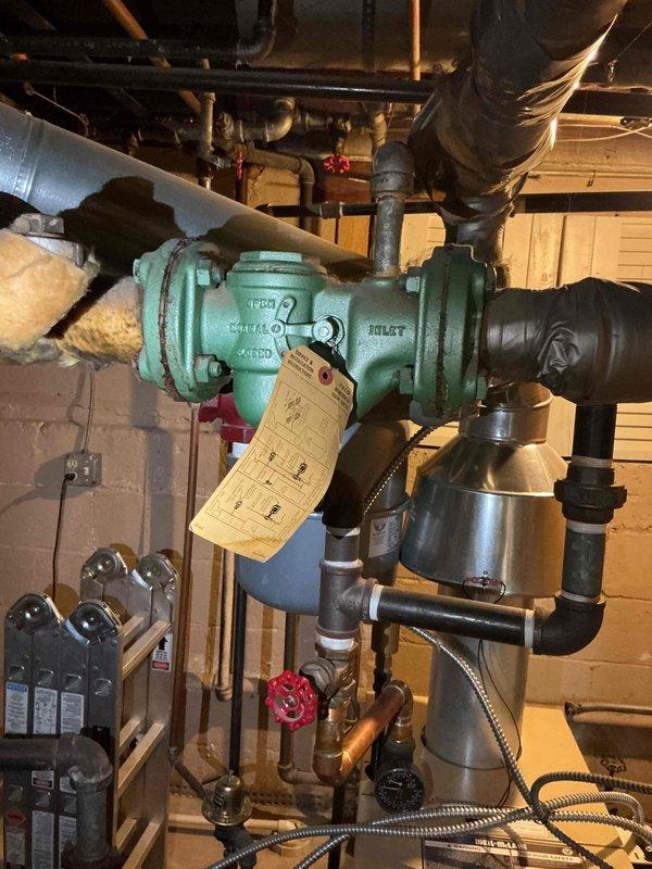 Responded to service call for leaking boiler pipes. Upon inspection, identified active leak at circulator pump connections in basement mechanical room. Observed aged turquoise circulator pump with visible wear on housing and fittings. Examined piping connections, flexible couplings, and valve assemblies surrounding the pump unit. Documented existing conditions with photographs showing pump assembly, copper piping, control valves, and associated plumbing infrastructure. Service provided under platinum plan membership at no charge. Discussed comfort plan options and verified all equipment information was recorded for service records.