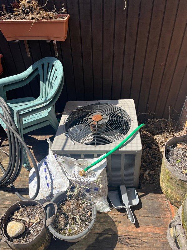 Conducted on-site evaluation for complete air conditioning system replacement. Existing condensing unit located on rear wooden deck accessible through interior of home shows significant age-related deterioration, corrosion on fan assembly, and rust staining throughout components. Unit has been non-operational for extended period. Documented equipment condition and deck-mounted installation location for preparation of replacement estimate and new system installation planning.