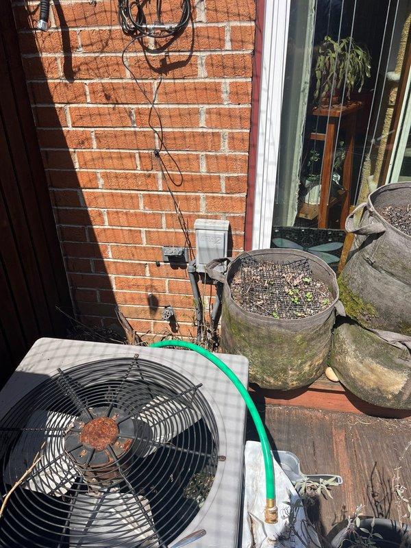 Conducted on-site evaluation for complete air conditioning system replacement. Existing condensing unit located on rear wooden deck accessible through interior of home shows significant age-related deterioration, corrosion on fan assembly, and rust staining throughout components. Unit has been non-operational for extended period. Documented equipment condition and deck-mounted installation location for preparation of replacement estimate and new system installation planning.