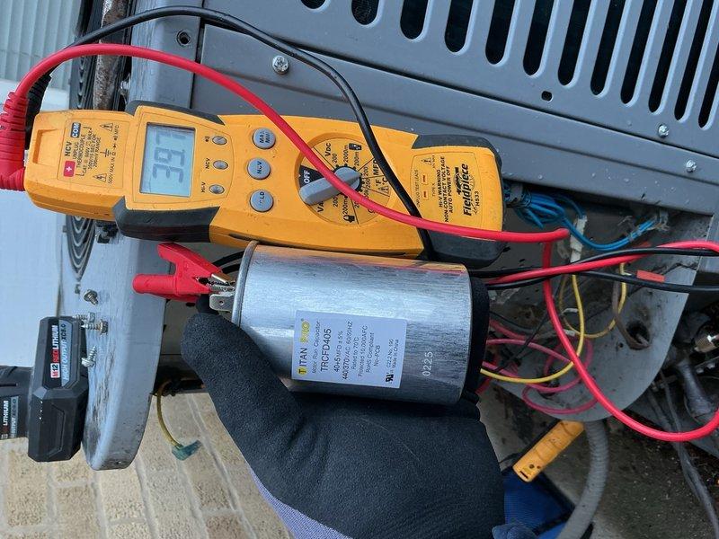 Responded to no-cool complaint on 8-year-old residential AC unit unable to maintain temperature below 76°F. Performed comprehensive electrical diagnostics using clamp meter and multimeter to test capacitor functionality and verify proper voltage and amperage readings across system components. Inspected contactor assembly, tested dual-run capacitor showing 53 microfarads on meter, and evaluated all electrical connections and wiring harnesses for proper operation.