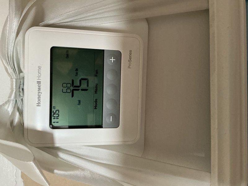 Responded to no cooling complaint on 9-month-old residential AC system. Upon arrival, found Honeywell ProSeries thermostat displaying 69°F setpoint with actual temperature reading of 63.5°F, indicating system was calling for cooling but not achieving desired temperature. Inspected attic-mounted air handler and associated components including refrigerant lines, flexible ductwork, and electrical connections. Diagnosed issue and performed necessary repairs to restore proper cooling operation. System tested and verified operational before departure.