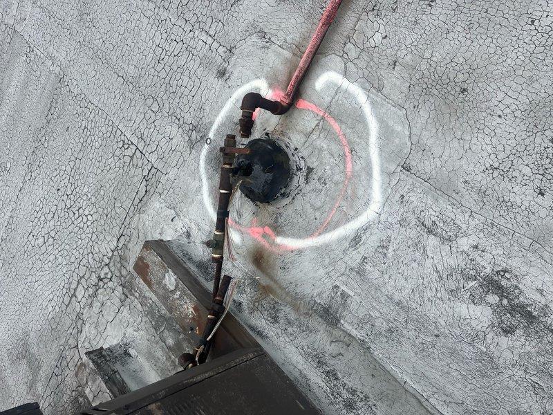 Verified refrigerant recovery on two decommissioned rooftop units in Unit H area, confirming proper removal with visual inspection markings. Removed exposed gas lines from rooftop surface and relocated them below the roof line into the warehouse through existing roof access point. Utilized scissor lift to safely access and complete all rooftop work on the weathered membrane surface.