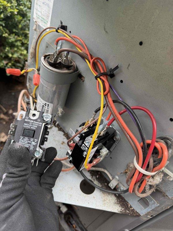 Responded to service call for Nest thermostat displaying error code on dual-system installation serving upper floor. Performed diagnostic inspection of affected AC unit, locating outdoor condensing unit with Zettler Controls contactor (model XMCO-251-DBBB, 208-240V). Inspected electrical control panel, verifying contactor operation, run capacitor condition, and all wire terminations including power and control wiring. Documented equipment condition showing normal wear and minor surface corrosion on enclosure. Presented maintenance options for both AC systems and comfort plan membership covering multiple HVAC units.