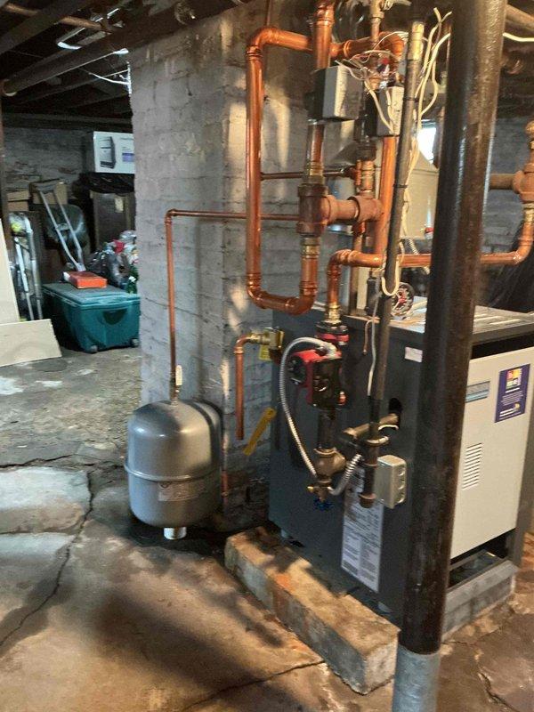 Replaced failed expansion tank on hydronic heating system. New expansion tank was installed and connected to existing copper piping network, restoring proper system pressure control and preventing potential boiler damage from thermal expansion issues.
