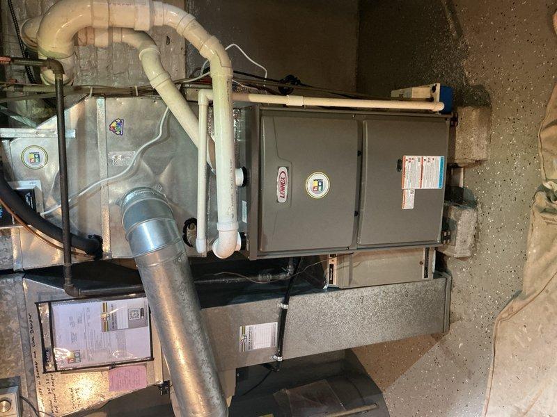 Removed and disposed of existing forced air furnace from basement utility area. Installed new Lennox 96% AFUE single-stage 88,000 BTU forced air furnace with connections to existing supply and return air ductwork, fabricating necessary sheet metal transitions to ensure proper fit. Connected unit to existing natural gas line, electrical circuit, and exhaust venting system using white PVC piping. Performed complete system start-up, tested and adjusted all components for optimal operation, and conducted comprehensive safety inspection to verify proper combustion, airflow, and venting. Unit is fully operational with 10-year parts warranty and 10-year extended labor agreement in effect.