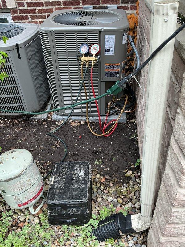 Corrected improper condenser installation that was positioned too close to building structure, preventing access to service ports and electrical compartment. Recovered refrigerant charge and disconnected unit. Added pea gravel base for proper leveling and rotated condenser 90 degrees to ensure adequate service clearance. Extended refrigerant lines using 3/4" and 3/8" line sets with press couplings and appropriate fittings. Replaced electrical whip to accommodate new unit orientation. Performed complete pressure test and vacuum procedure, recharged system to manufacturer specifications, and tested for proper operation with homeowner present.