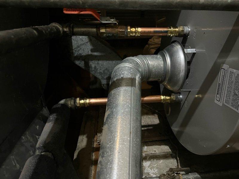 Drained down and disconnected existing water heater in basement, then removed and disposed of old unit. Installed vibration isolation pads on floor to ensure stable, level platform, then positioned drain pan. Provided and installed new 40-gallon commercial tanked water heater in same location. Connected unit to existing exhaust chimney piping, gas line, electrical supply, and water piping. Performed start-up procedures, tested all connections for proper operation, and conducted comprehensive safety inspection. Verified temperature settings, checked for gas leaks at connections, confirmed proper venting and draft, and ensured water supply and discharge lines were secure and leak-free. Unit operating within manufacturer specifications upon completion. Installation includes 6-year warranty on tank and functional parts with 1-year labor warranty.