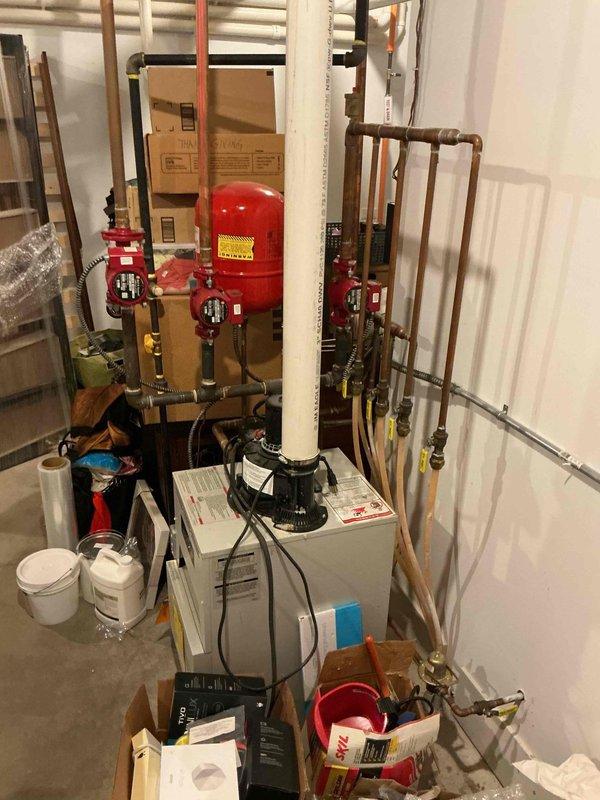 Replaced defective pressure switch on power vent boiler system to restore proper operation. Retrieved replacement part from office, completed installation, tested system functionality, and collected photo documentation of the hydronic heating system including expansion tank, circulator pump, and associated piping components.