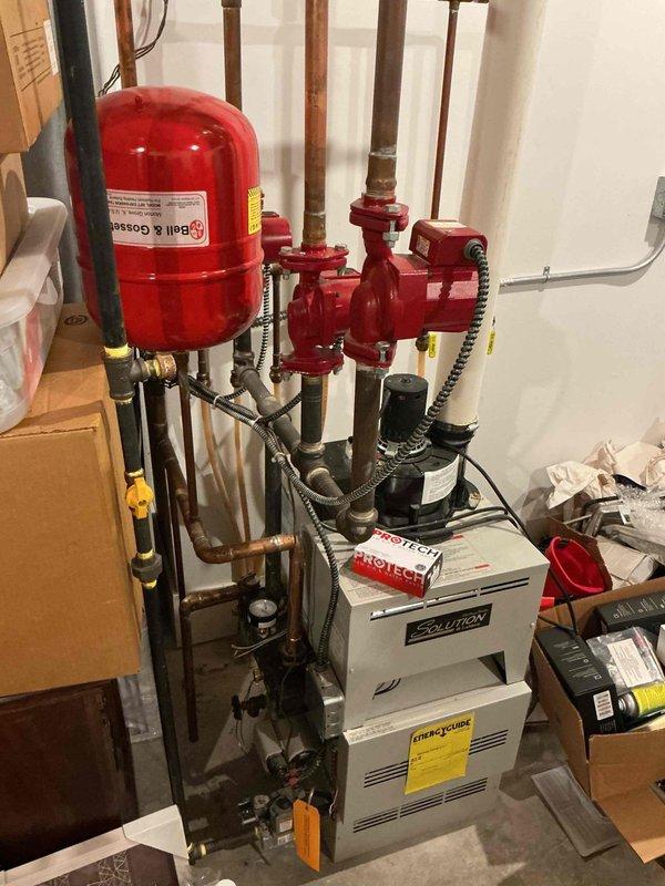 Replaced defective pressure switch on power vent boiler system to restore proper operation. Retrieved replacement part from office, completed installation, tested system functionality, and collected photo documentation of the hydronic heating system including expansion tank, circulator pump, and associated piping components.