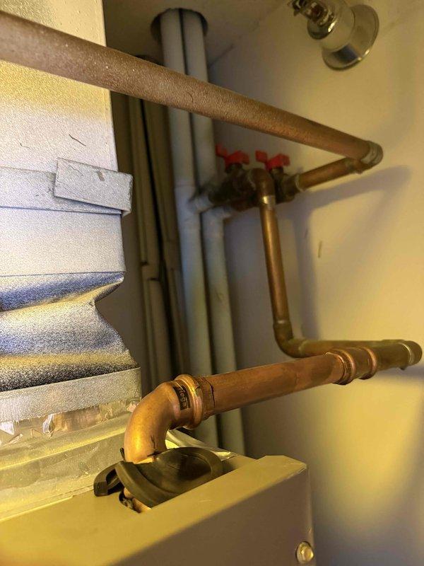 Completed comprehensive tune-up on single HVAC system including air handler and hydronic coil components. Performed electrical diagnostics with clamp meter readings, inspected refrigerant lines and ductwork connections, and verified proper operation of all mechanical components. Installed 16x20x1 air filter, documented existing plumbing configuration with red-handled shut-off valves on copper piping, and provided customer with information regarding optional zone valve installation for hydronic coil temperature control.