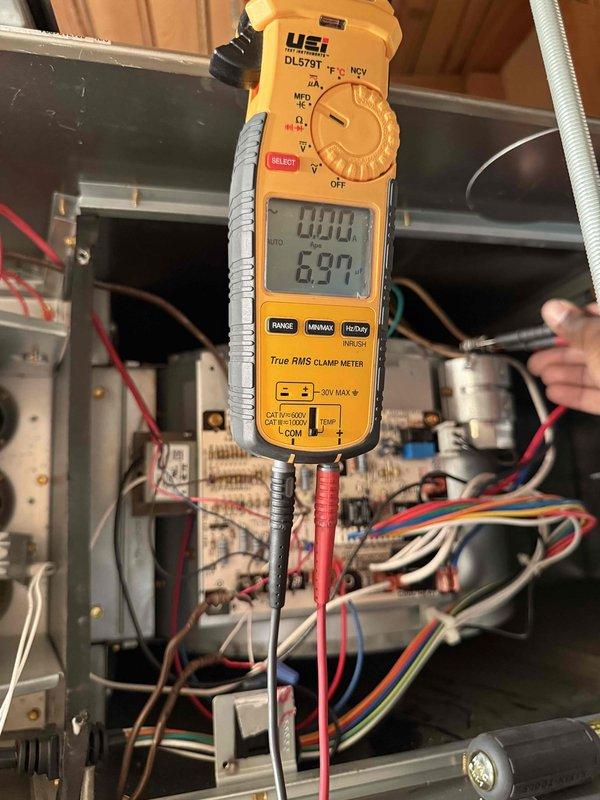 Completed annual air conditioning clean and check maintenance per Comfort Plan agreement. Performed comprehensive system inspection including electrical measurements with clamp meter showing 6.97 amp draw, verified supply air temperature at 57°F, and inspected all internal components including capacitors, wiring connections, and control boards. All components operating within normal parameters with no deficiencies noted.