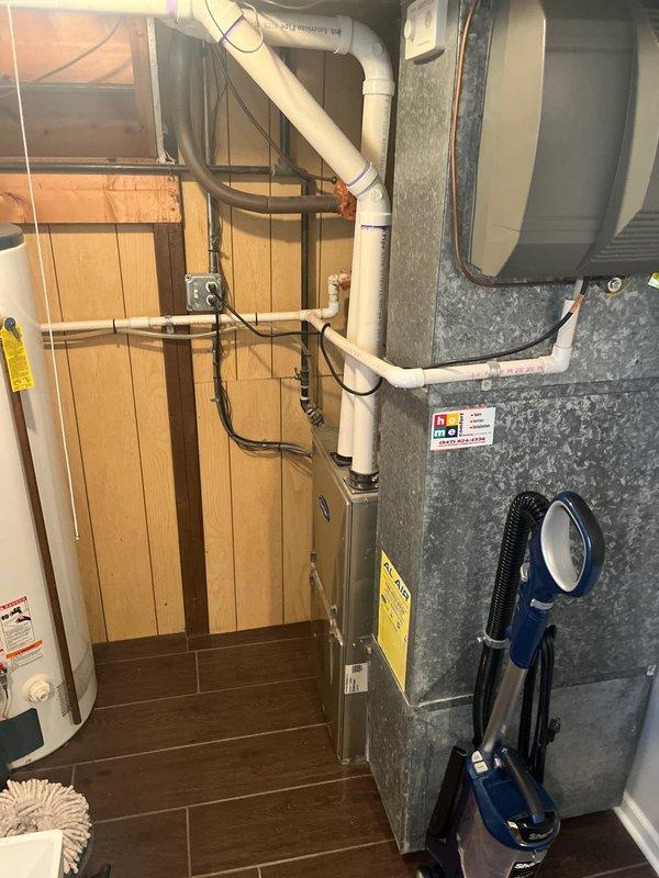 Conducted comprehensive estimate for replacement of residential air conditioning system for ranch-style home. Existing outdoor condenser unit is over 10 years old and requires full replacement. Evaluated current HVAC installation including outdoor AC condenser unit positioned on concrete pad adjacent to building exterior, and inspected indoor air handler/furnace system located in basement with existing PVC condensate drainage and venting infrastructure. Provided new customer with detailed replacement options and specifications for complete AC system upgrade.