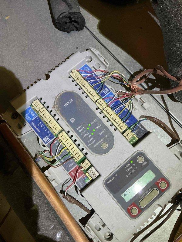 Performed warranty follow-up on newly installed Unico HVAC system to address mechanical vibration and control box rattling issues. Verified refrigerant charge levels and inspected recovered refrigerant in upstairs recovery tank to ensure proper system charging. Tested both heating and cooling operations across all zones using second floor thermostat and unit-mounted thermostat to confirm proper zone control functionality and system performance.