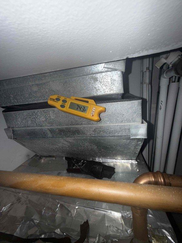 Responded to no cooling complaint on residential air conditioning system. Upon inspection, found severely restricted airflow due to heavily soiled air filter with significant dust and debris accumulation. Measured supply air temperature at 73.3°F and return air temperature at 83.8°F, confirming inadequate cooling performance. Observed one refrigerant line running cold and suction line running warm, indicating potential low refrigerant charge or restricted airflow affecting system operation. Identified dirty filter as primary cause of reduced system efficiency and inadequate temperature differential. Replaced air filter and restored proper airflow to system. Verified thermostat settings and confirmed unit cycling properly. System operating within normal parameters following filter replacement with improved temperature split across evaporator coil.