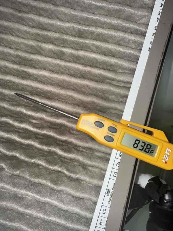 Responded to no cooling complaint on residential air conditioning system. Upon inspection, found severely restricted airflow due to heavily soiled air filter with significant dust and debris accumulation. Measured supply air temperature at 73.3°F and return air temperature at 83.8°F, confirming inadequate cooling performance. Observed one refrigerant line running cold and suction line running warm, indicating potential low refrigerant charge or restricted airflow affecting system operation. Identified dirty filter as primary cause of reduced system efficiency and inadequate temperature differential. Replaced air filter and restored proper airflow to system. Verified thermostat settings and confirmed unit cycling properly. System operating within normal parameters following filter replacement with improved temperature split across evaporator coil.