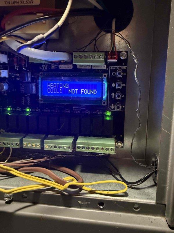 Responded to no cooling complaint on warranty equipment consisting of SpacePak air handler model ESP-4860J and American Standard condensing unit model 4A7A3060E1000NA installed in 2020. Upon arrival, found frozen evaporator coil and control board displaying "HEATING COIL1 NOT FOUND" error message, indicating communication fault between air handler and heating coil sensor. Performed diagnostic testing using clamp meter to verify electrical readings and inspected control board connections, LED indicators, and wiring harness for proper operation and connectivity issues affecting system performance.
