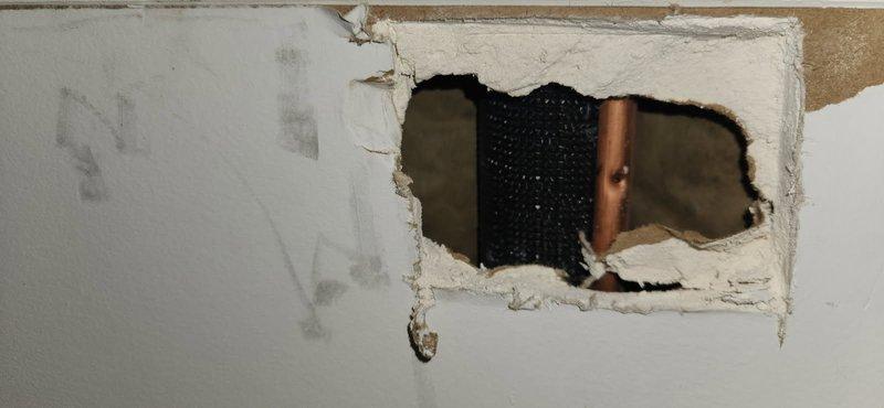 Diagnosed outdoor AC unit not receiving signal from thermostat. Investigation revealed damaged low-voltage wiring in wall cavity between indoor and outdoor units. Created access points in interior wall and ceiling to locate and repair broken thermostat wire, restored proper communication between system components, and verified unit operation upon completion.