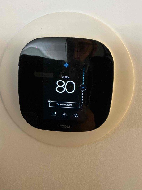 Responded to no cooling complaint at residential property. Upon arrival, found ecobee smart thermostat calling for cooling with system set to 80°F while indoor temperature reading 74°F. Performed diagnostic evaluation of furnace and air conditioning system. Inspected furnace unit and associated components including refrigerant lines and condensate drainage system. Documented equipment information and captured photographs of thermostat display and HVAC equipment for service records.