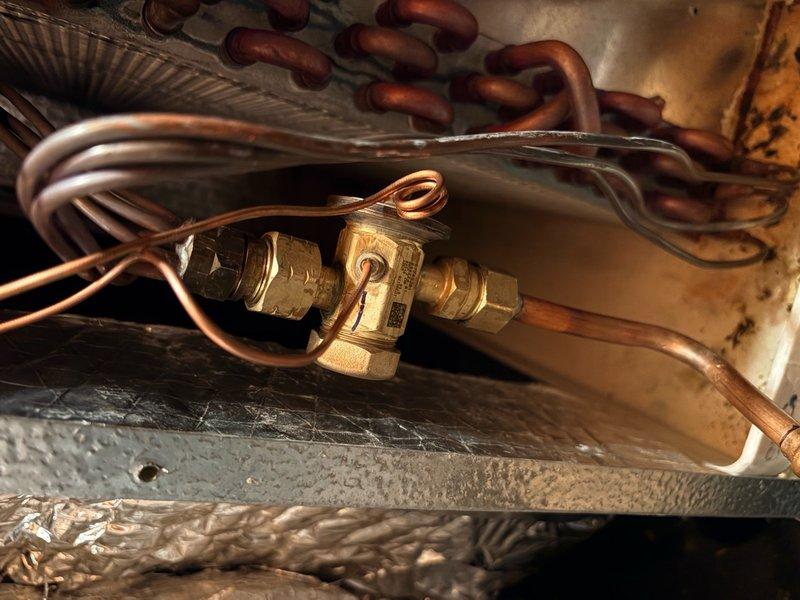 Replaced defective thermostatic expansion valve (TXV) under warranty on residential HVAC system. Coordinated part delivery to job site, removed and replaced faulty TXV, and returned defective component to office for warranty processing. System tested and confirmed operational upon completion.