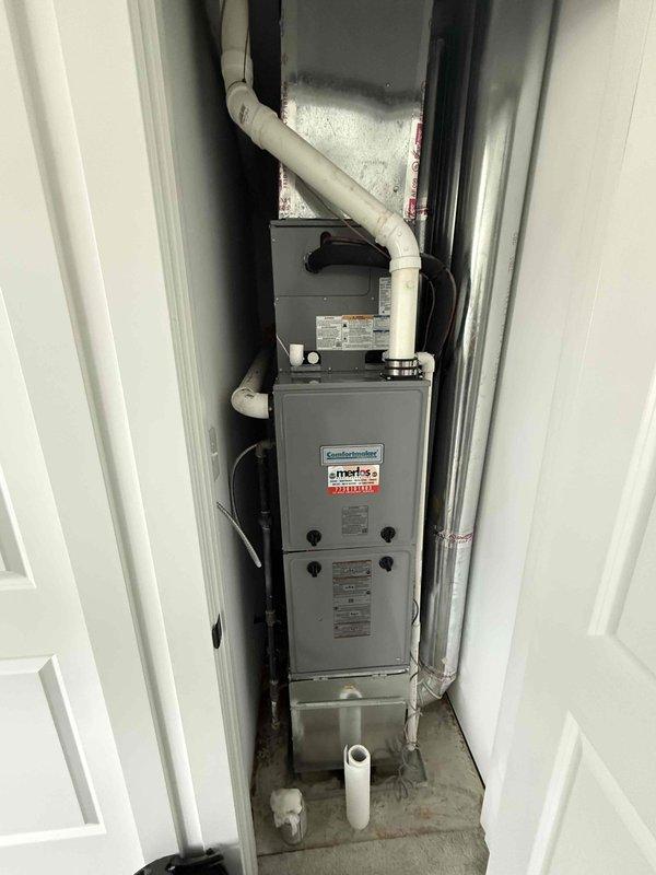 Responded to water leak issue on second floor HVAC unit where three drain connections were actively leaking and had triggered the water detection device. Upon inspection, identified compromised PVC drainage connections requiring replacement with properly sized 3/4-inch PVC piping to restore proper condensate drainage to the system. Documented equipment information and captured photographic evidence of the furnace installation and drainage configuration within the utility closet for service records.