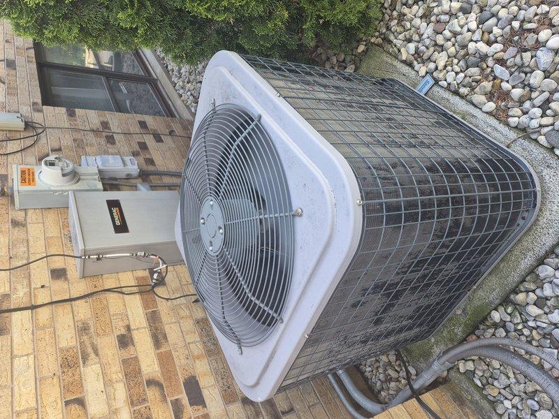 Completed comprehensive clean and check maintenance service on residential air conditioning system per comfort plan agreement. Performed thorough inspection of outdoor condenser unit, noting accumulated debris on protective mesh grille which was cleaned during service. Conducted electrical diagnostics using digital multimeter to verify proper voltage and amperage readings at the unit. Inspected disconnect box, capacitor, and all electrical connections for proper operation and safety compliance. All components found operating within manufacturer specifications upon completion of maintenance procedures.