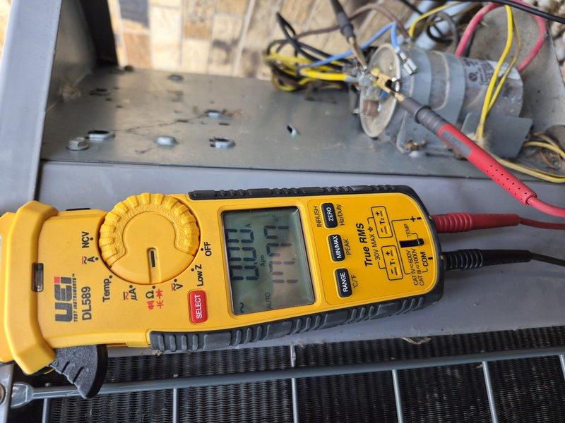 Completed comprehensive clean and check maintenance service on residential air conditioning system per comfort plan agreement. Performed thorough inspection of outdoor condenser unit, noting accumulated debris on protective mesh grille which was cleaned during service. Conducted electrical diagnostics using digital multimeter to verify proper voltage and amperage readings at the unit. Inspected disconnect box, capacitor, and all electrical connections for proper operation and safety compliance. All components found operating within manufacturer specifications upon completion of maintenance procedures.