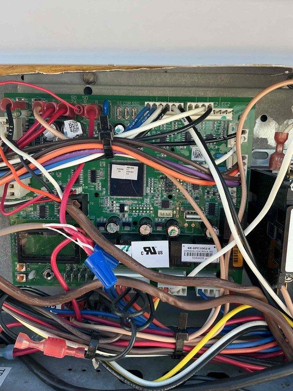 Replaced failed circuit board on rooftop unit (RTU). Removed defective green PCB control board from metal enclosure and installed new replacement board. Reconnected all wiring harnesses including power connections, control wiring, and communication cables to proper terminals on new circuit board. Verified all wire connections were secure at terminal blocks and connectors. Tested system operation after board replacement to confirm proper function of RTU controls and variable frequency drive (VFD) motor operation. Collected outstanding balance on invoice.