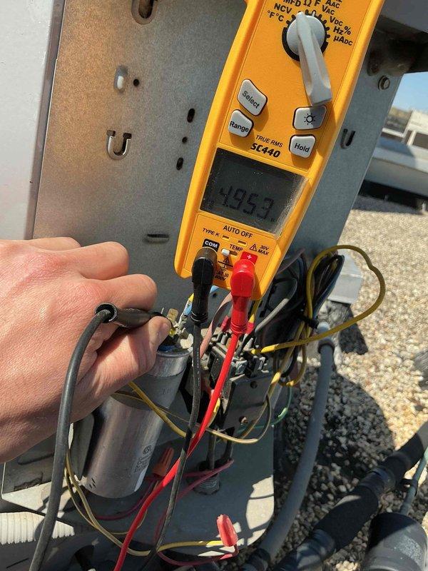 Completed spring preventive maintenance on commercial HVAC system including two rooftop units and indoor air handler. Responded to service calls for loud noise from West RTU and cooling issues on East RTU. Performed diagnostic testing on electrical components including capacitor testing with multimeter, recording readings of 4053 on West unit capacitor. Conducted clean and check procedures on both York rooftop units, replaced all air filters per maintenance agreement specifications (14x25x1 and 14x20x1 sizes as required for each unit), and performed filter change only on York furnace in mechanical room. Inspected electrical connections, contactors, relays, and condensate drainage systems on both RTUs. Documented equipment conditions and component markings for service records.