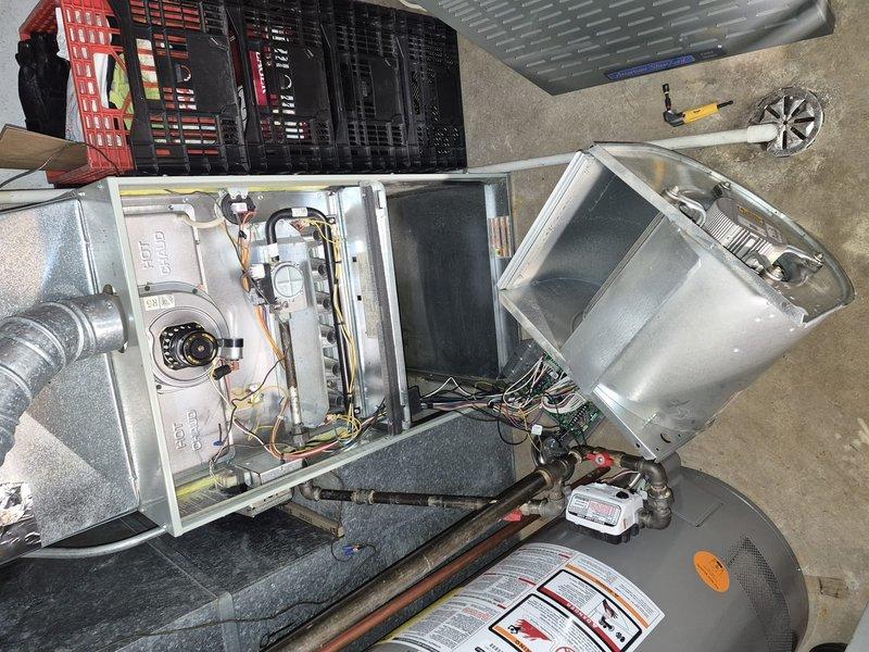 Performed blower wheel cleaning on residential furnace system. Removed blower assembly from unit, extracted heavily soiled squirrel cage fan wheel showing significant dirt and debris accumulation on blades, and thoroughly cleaned component before reinstallation and system testing.